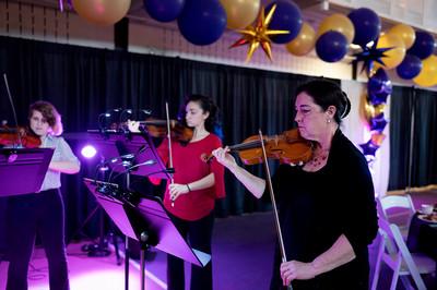 Faculty and students playing string instruments