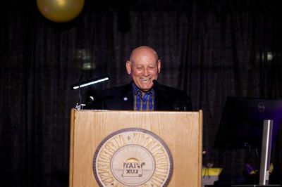 Man smiling at a podium